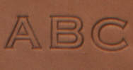 swatch of British Tan debossed leather with initials